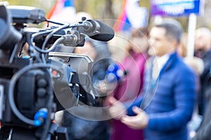 Filming media event with a video camera. News or press conference.