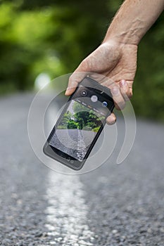 Filming on a mobile phone. Phone in hand.