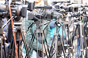 Filming press conference or media event with a television camera