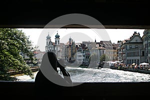 Filming woman upon a bridge over the river Reuss in Luzern