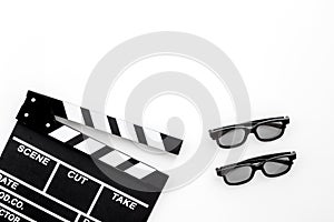 Filmmaker accessories. Clapperboard and glasses on white background top view copyspace