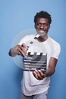 Filmmaker holding open clapper photo