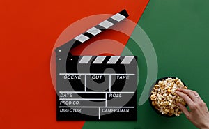 Filmmaking concept. Movie Clapperboard. Cinema begins with movie clappers. Movie clapper board on green and on red background and