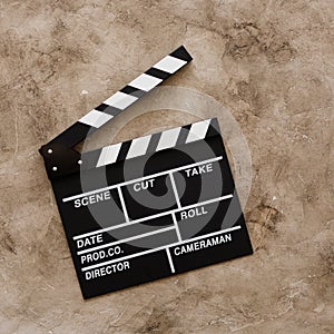 Filmmaking concept. Movie Clapperboard. Cinema begins with movie clappers. Movie clapper board on a textural background. Square