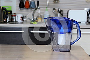 Filter for cleaning drinking water on the table in the kitchen. Purification of drinking water at home