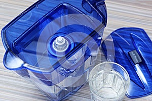 Filter for cleaning drinking water on the table in the kitchen. Purification of drinking water at home