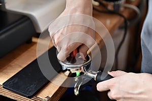 Filter holder filled with freshly ground coffee. Espresso accessory.