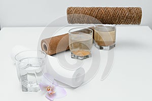 Filter system for water treatment with glasses of clean and dirty water on bright background