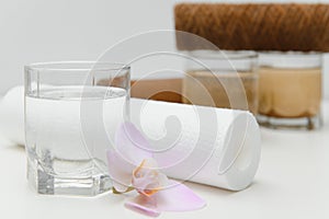 Filter system for water treatment with glasses of clean and dirty water on bright background