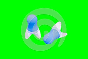 Filtered earplugs for airplane flying that help to equalize the pressure against your eardrum isolated on green chroma key