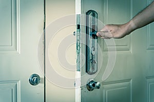 Filtered image Asian male hand open door knob of apartment in Hanoi, Vietnam