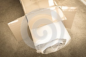 Filtered image close-up roll-packed spring mattresses unbox on carpet floor background