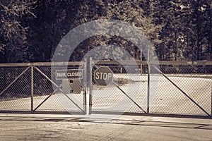 Filtered image gate closed at the entrance to park and nature preserve in suburban Houston, Texas, USA