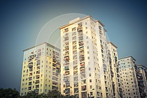 Filtered image lookup typical condos with hanging clothes over blue sky in Hanoi, Vietnam