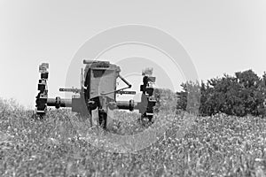 Filtered image rural scene in Texas with old tractor and Bluebonnet blossom in springtime