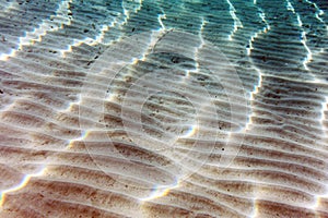 Filtered Sunlight Streaks on Sandy Sea Bottom