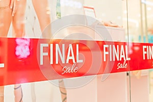 final SALE white word on red Fabrik backdrop in shop window. Summer sale. special offer, big sale concept. Discounts