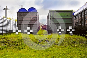 At the final station, freight wagons stand, in front of them are large signs of railway deadlock