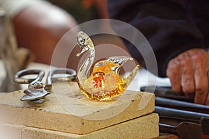 Final work in the manufacturing and modeling process of a glass figure, Murano, Venice, Italy