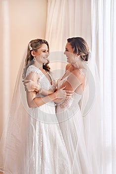 This is finally happening. two attractive young brides holding each other in excitement before their wedding.