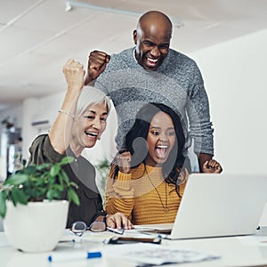 Finally were getting somewhere. Cropped shot of a group of cheerful businesspeople looking at a laptop screen together