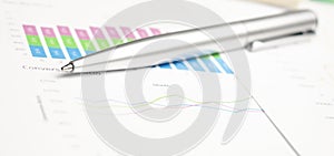 Finance analysis concept - a chart with a pen and a calculator