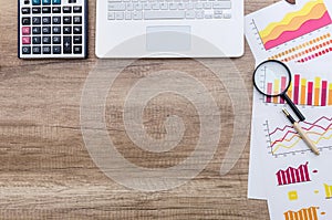 Finance analyst working place with magnifying glass.