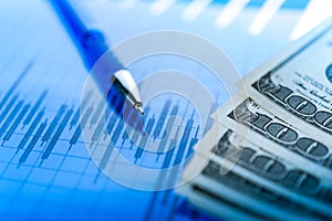 Finance background with money, stock market chart, graph and pen. Economy and business concept.