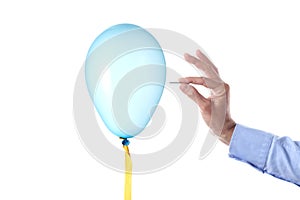 Finance burst concept: caucasian man`s hand holding a nail burst a party balloon isolated with clipping path