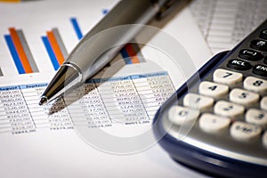 Finance, business budget planning and analysis concept, graph report with calculator on office desk