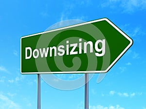 Finance concept: Downsizing on road sign background