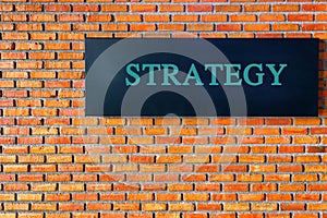 Finance concept: Strategy text on brick wall background