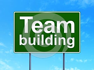 Finance concept: Team Building on road sign background