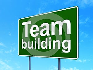 Finance concept: Team Building on road sign background