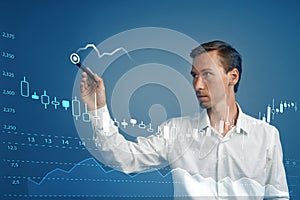 Finance data concept. Man working with Analytics. Chart graph information with Japanese candles on digital screen.