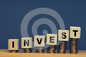 Finance And Investment Concept with wooden block stacked on coins