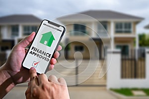 Finance loan agreement and house key Mortgage Loan approval on mobile phone in a house photo