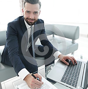 Finance manager working with business graphics on a laptop