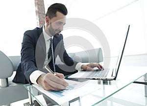 Finance manager working with business graphics on a laptop