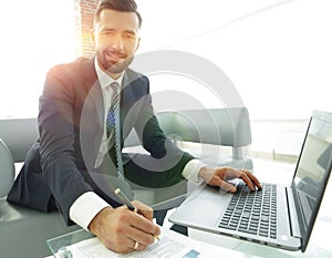 Finance manager working with business graphics on a laptop