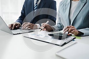 Finance and Marketing Business Meeting, Two businessmen are meeting together and looking at financial and marketing documents to