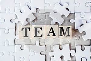 Finance and marketing teamwork concept with text on jigsaw puzzle background