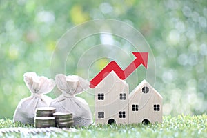 Finance, Model house with red arrow graph and money bag on natural green background,Business investment and Save money for prepare