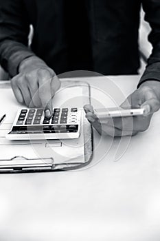 Finance person table`s or workplace`s close up a shot while he was doing some finance and loan-related work with cell phone, calcu