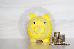 Finance, Piggy bank and coins money on wooden background, Save money for prepare in future and pension retirement concept