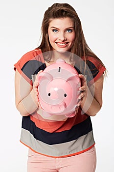 Finance, portrait and woman with piggy bank in studio for savings, payment our budget on white background. Money, box or photo