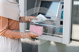 Finance, salary, money transfer at modern ATM outdoor, money withdraw, currency and social distancing