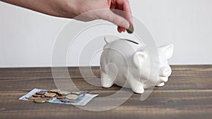 Finance saving concept. Money throwing in the piggy bank euro coins