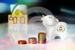 Finance savings and growth concept. 2021 bull symbol with dollar sign on belly and coins stacked vertically, dark background with