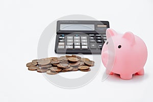 Finance Savings, save money for future investments and for emergency use concept. A pink piggybank, money and calculator